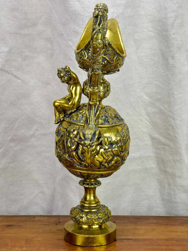 Bronze Napoleon III pitcher adorned with foliage, fruit and a cherub 17¾"