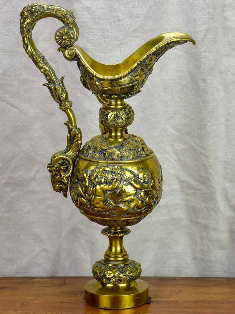 Bronze Napoleon III pitcher adorned with foliage, fruit and a cherub 17¾"